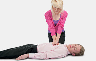 Woman doing chest compressions on male casualty